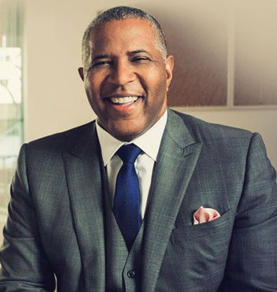 Headshot of Robert F. Smith as he wears a suit and smiles for the camera.