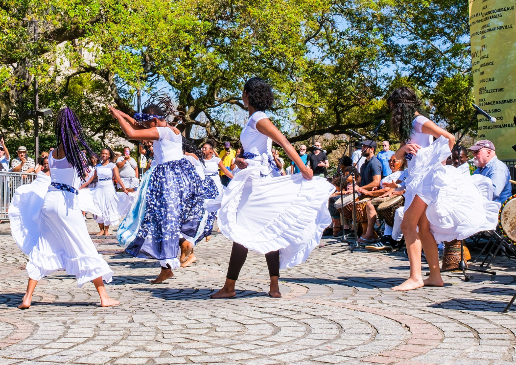 Image of a group of people dancing in the street of New Orleans, LA