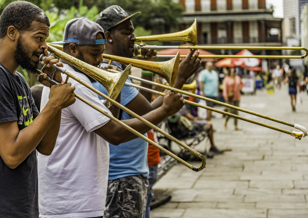 Image of four men playing the trumpet on the side of the street in New Orleans,LA